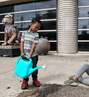 Kid watering plants